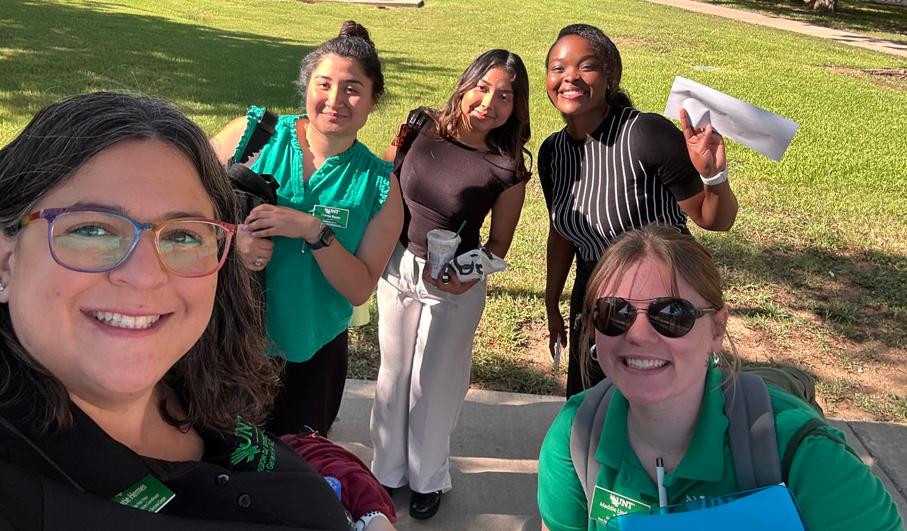 Volunteers take selfie at community event.