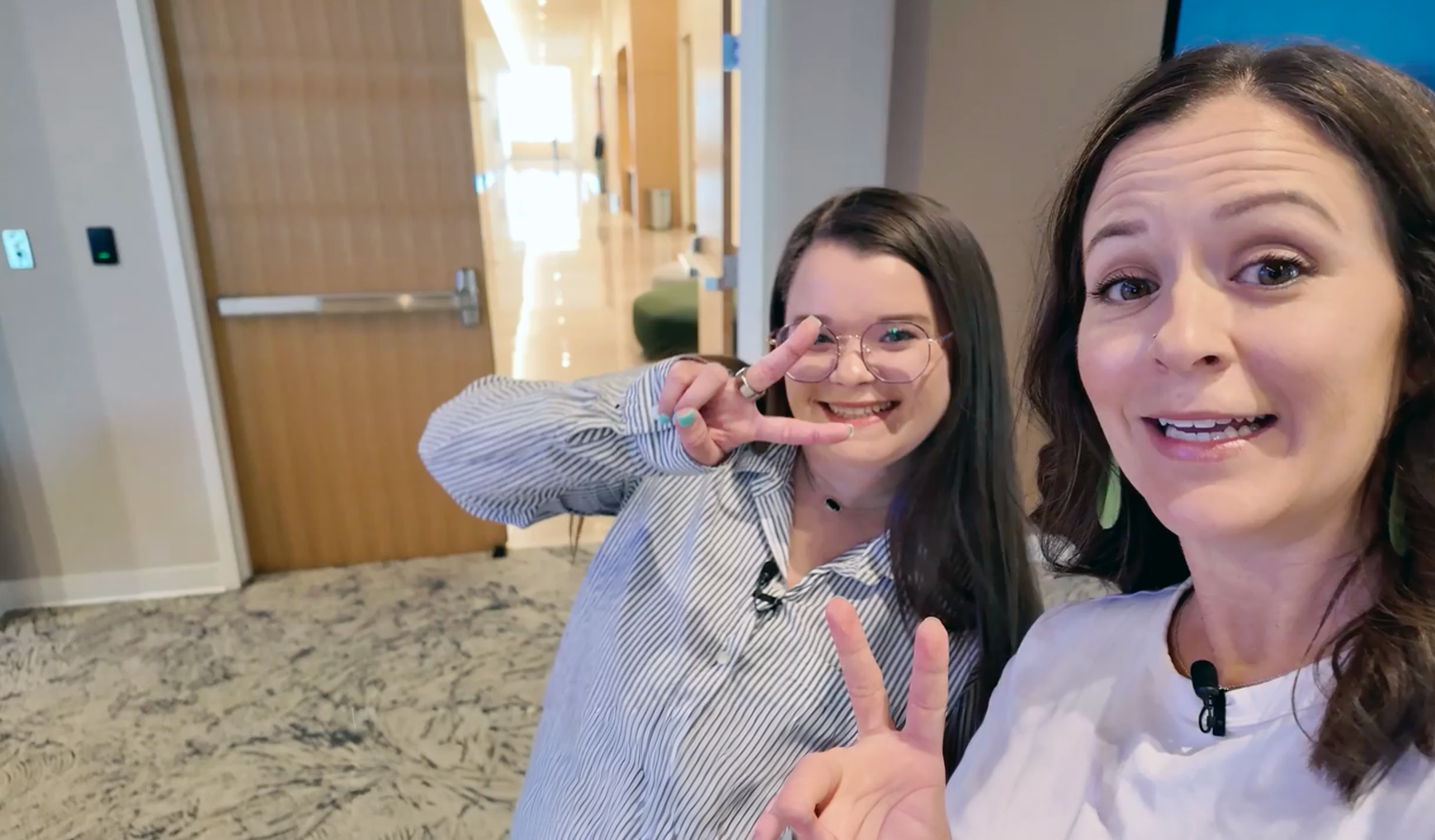 Woman and girl pose cheerfully together.