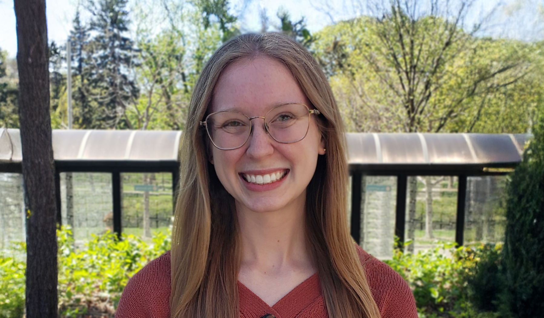 Young woman smiles outdoors in spring.