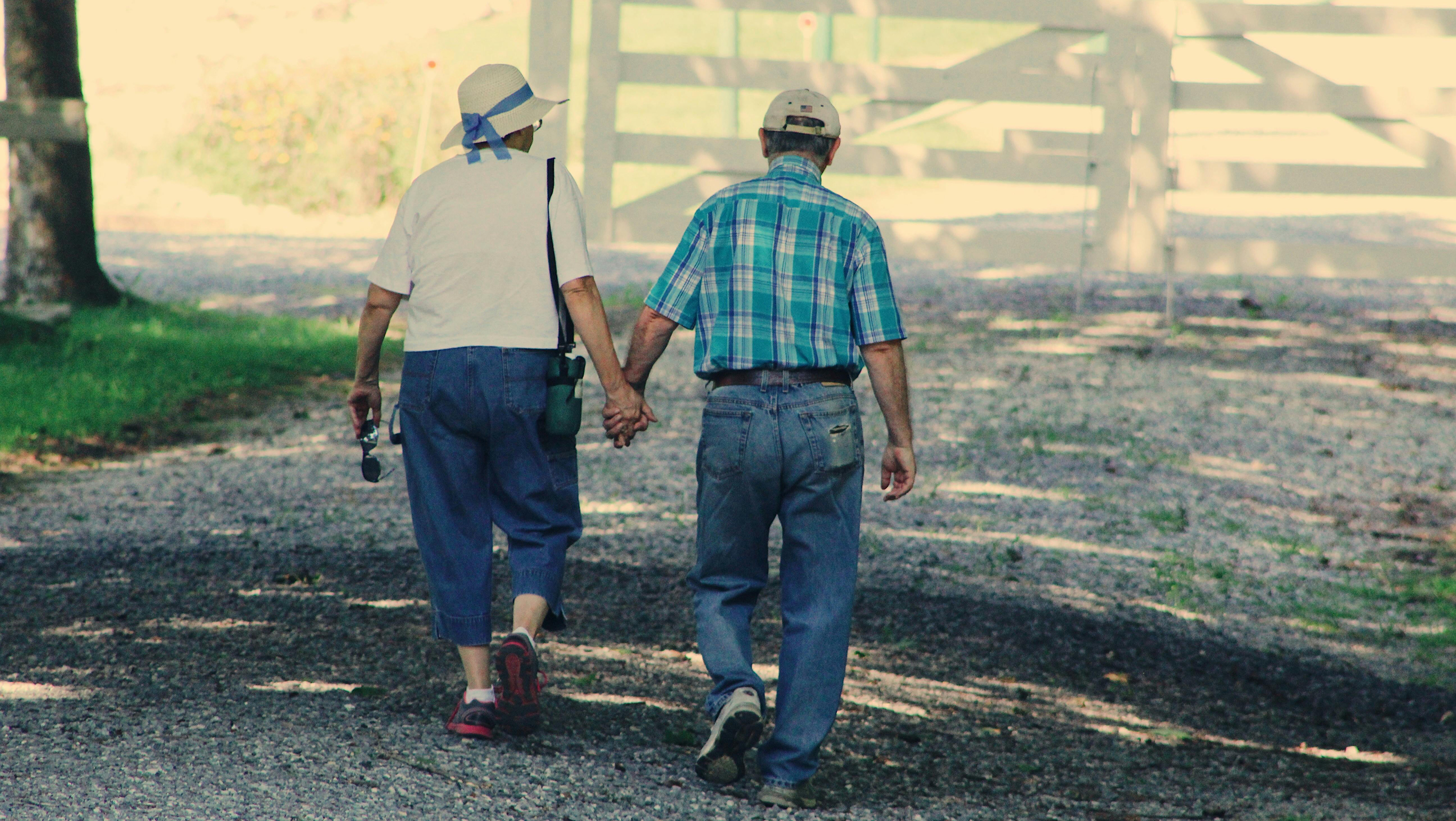 An old couple walking and holding hands