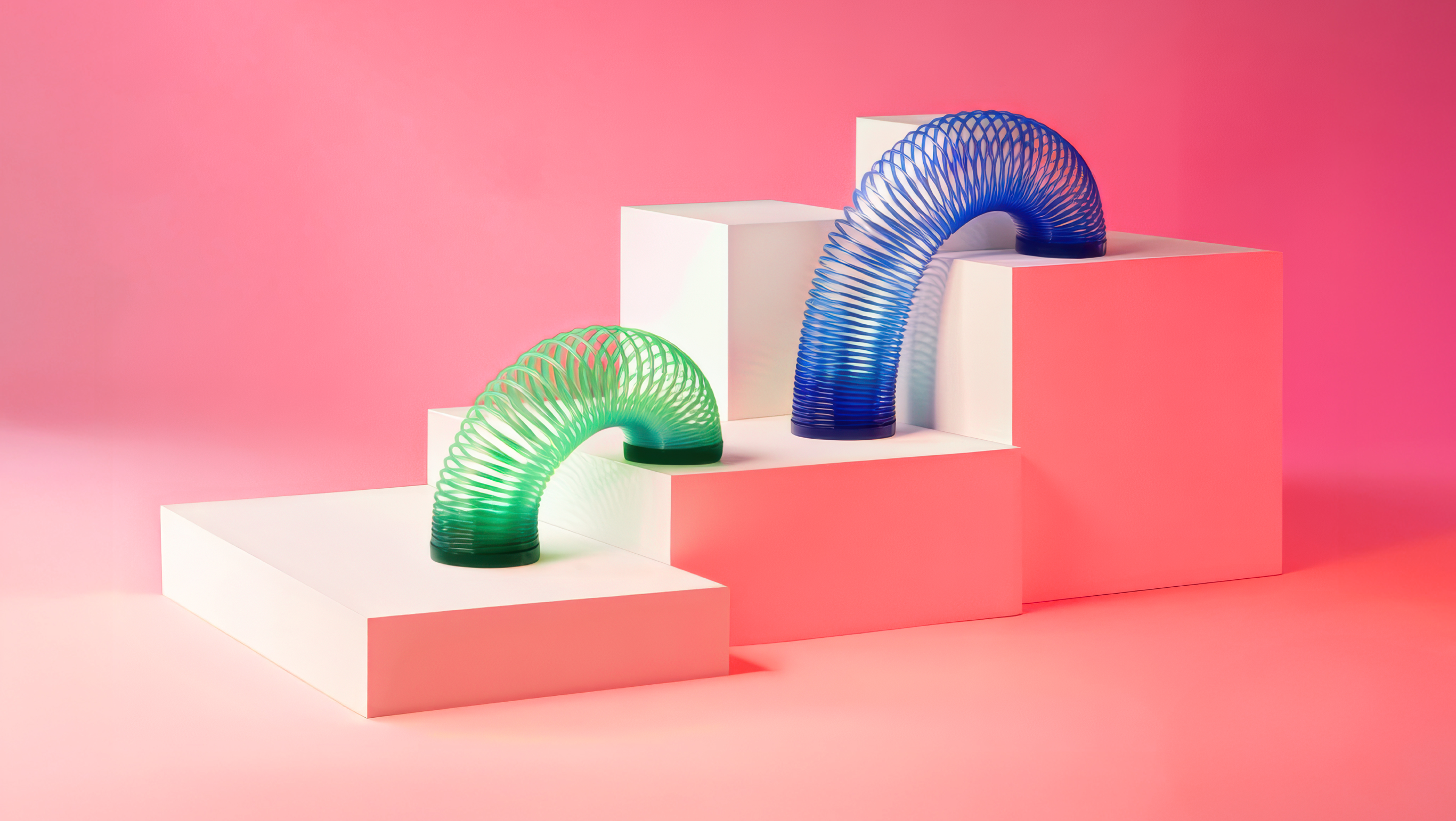 Slinky toys climbing the steps of a bar chart represent the flexible thinking health care and higher ed employers are using in order to grow.