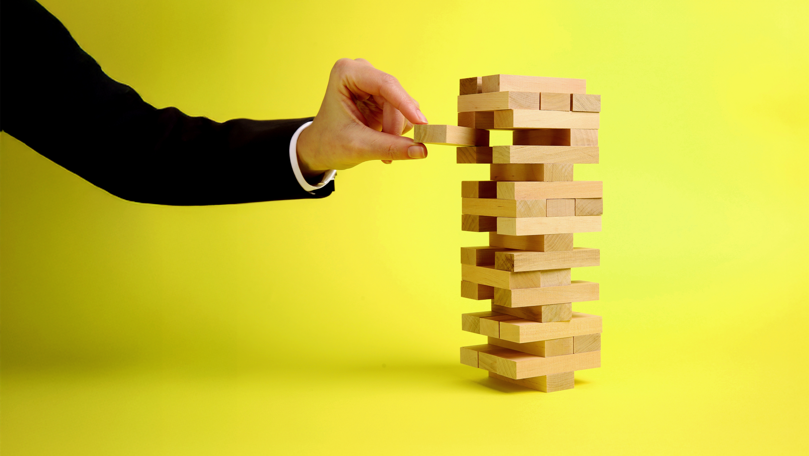 A wood block balance game represents the delicate approach nonprofits will have to take as they address new U.S. government policy in 2026.