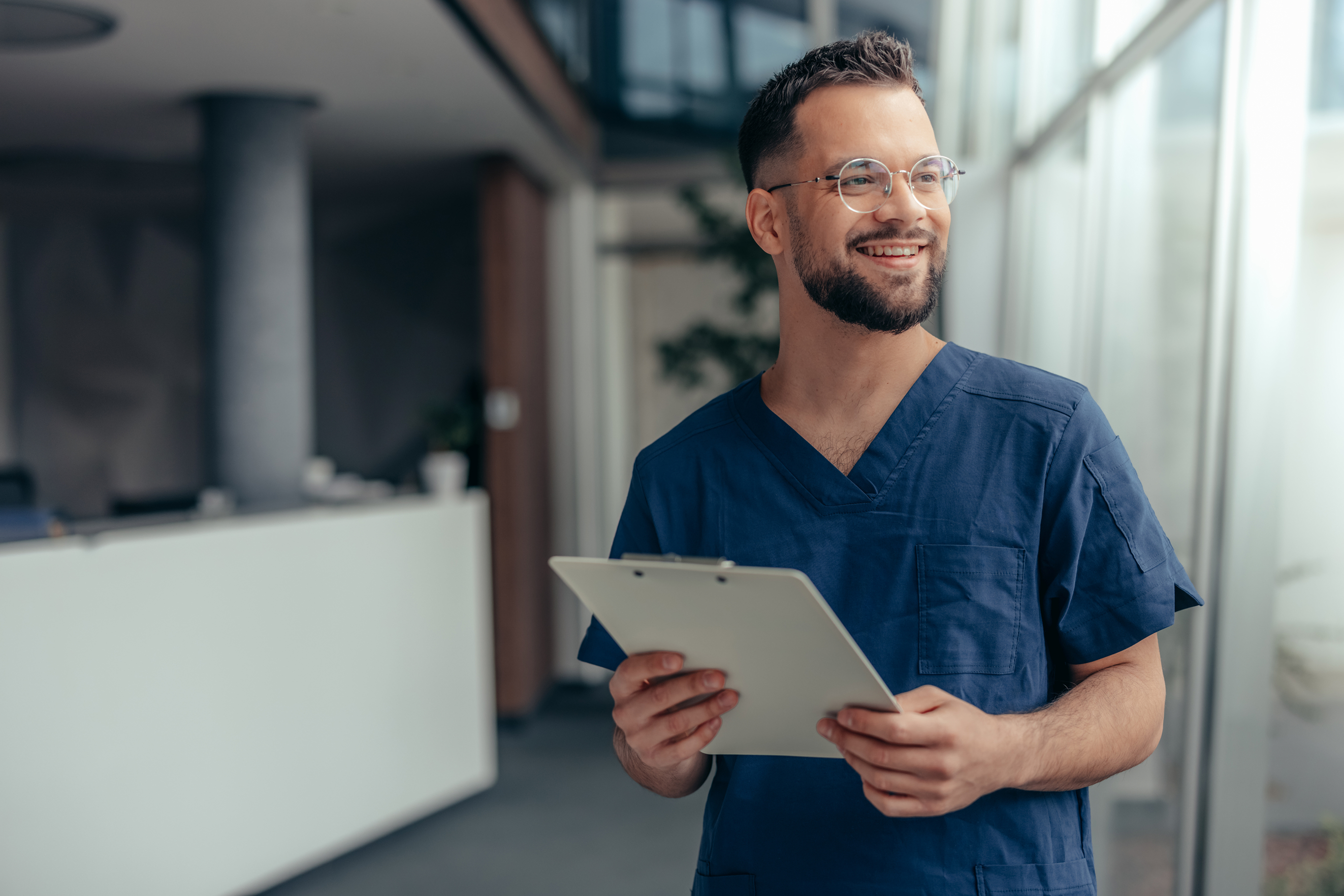 Male healthcare professional thinks about his future during a busy workday.
