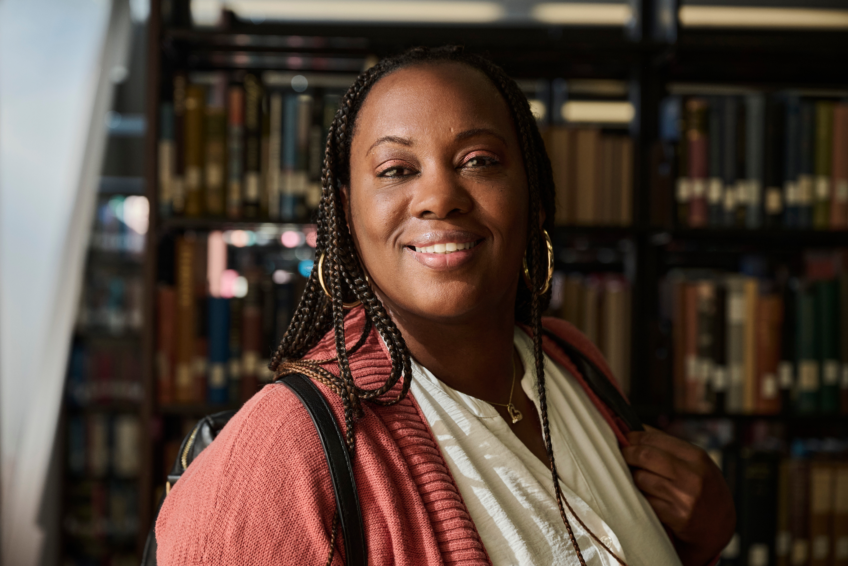 A woman faces the camera with a smile.