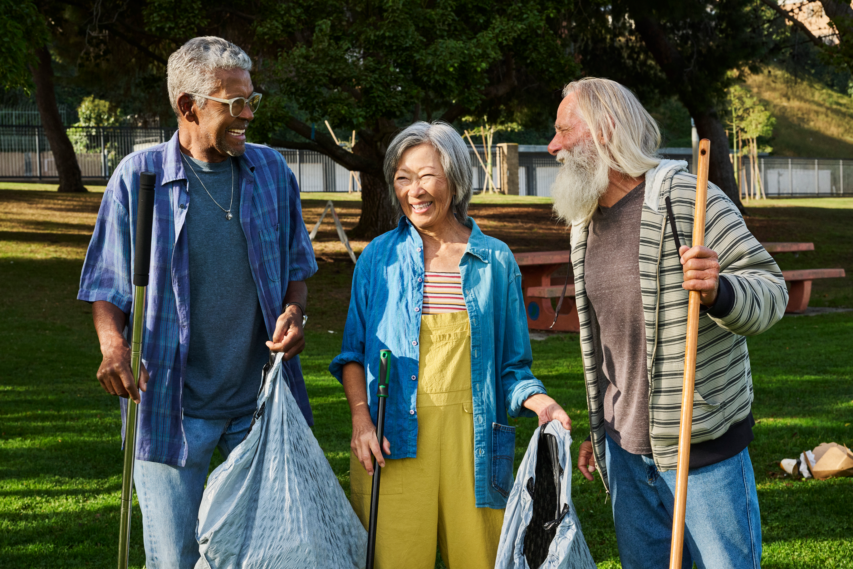 Three people walking outside talking.