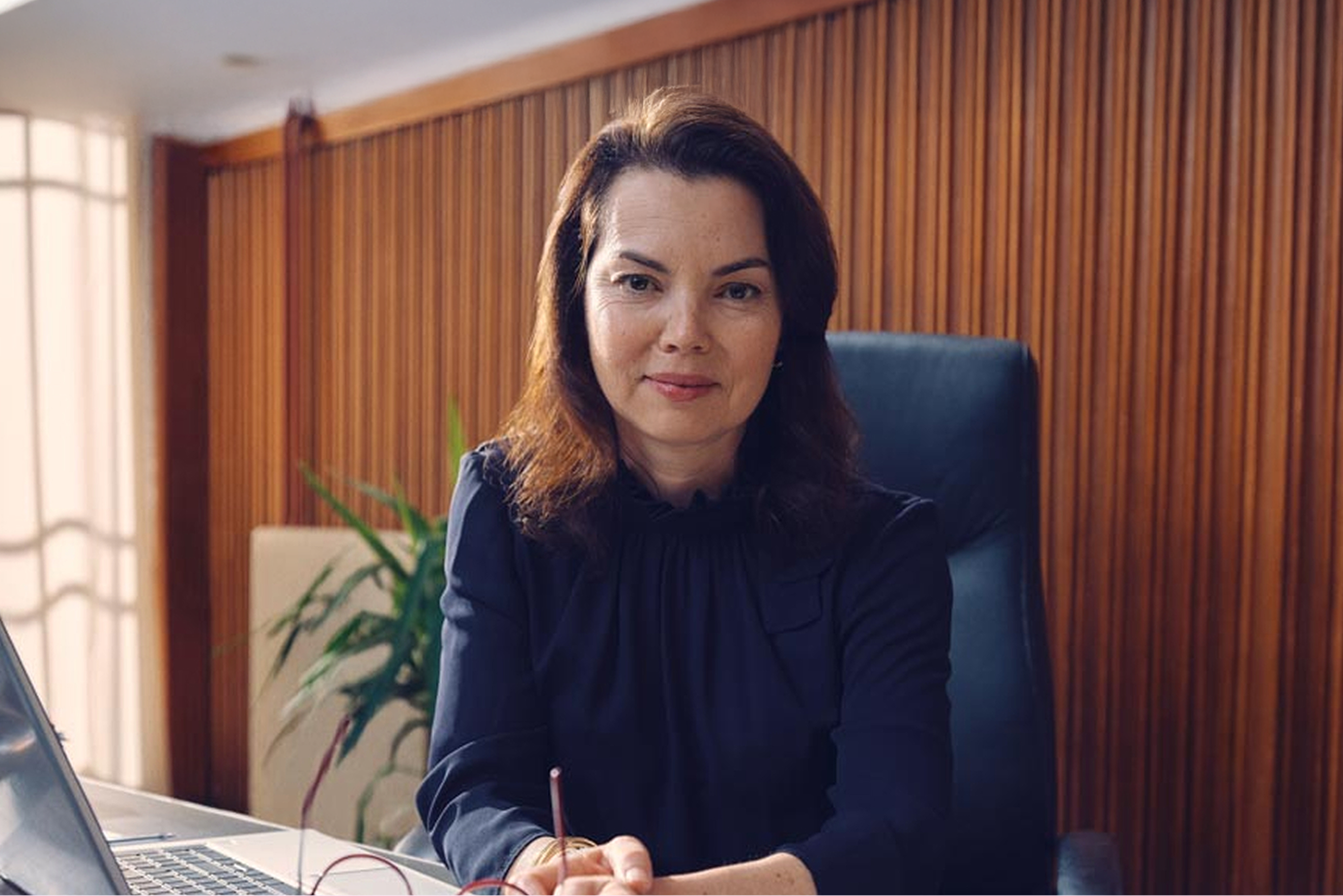 A woman sits at her desk working.