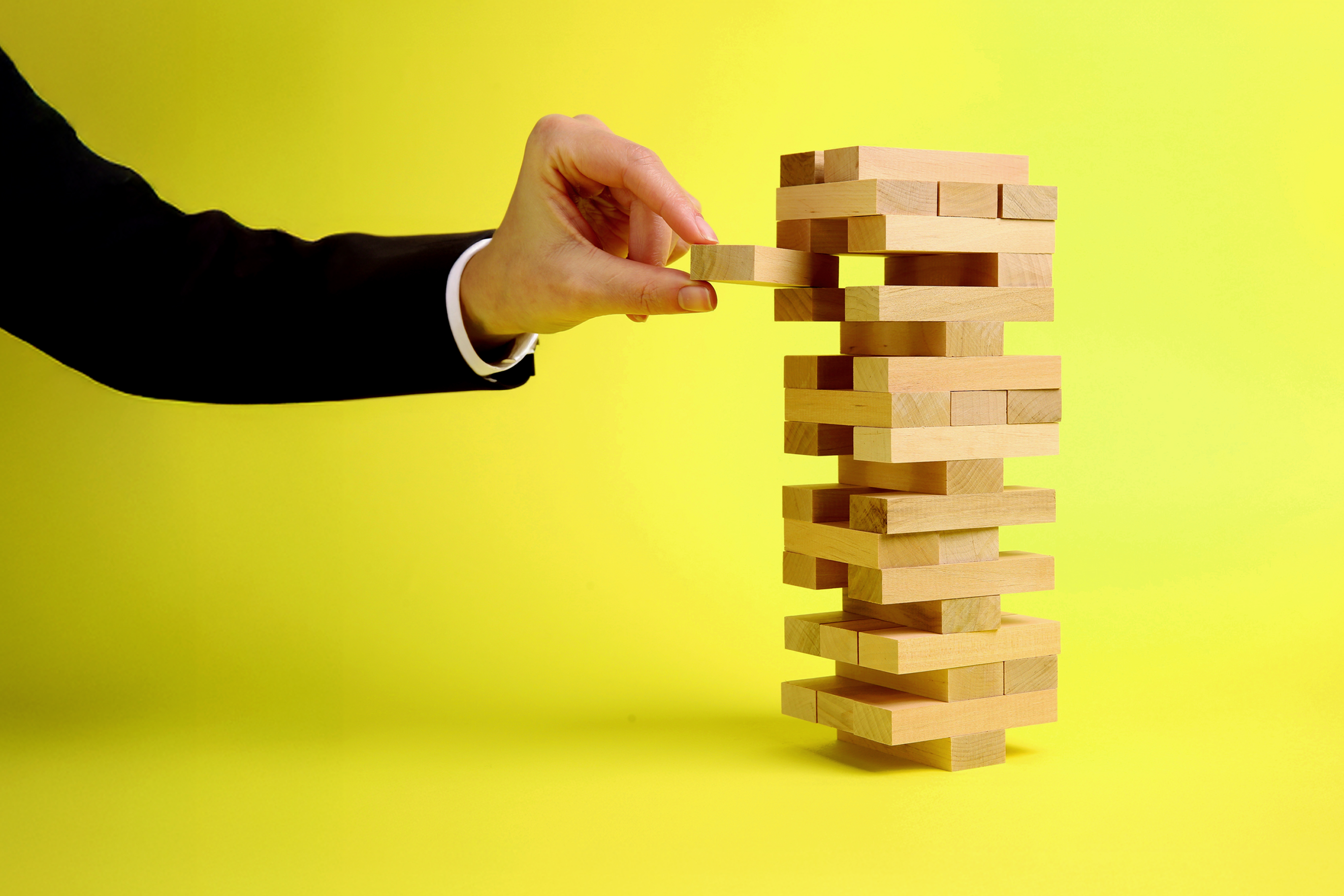 A wood block balance game represents the delicate approach nonprofits take as they address new U.S. government policy in 2026.