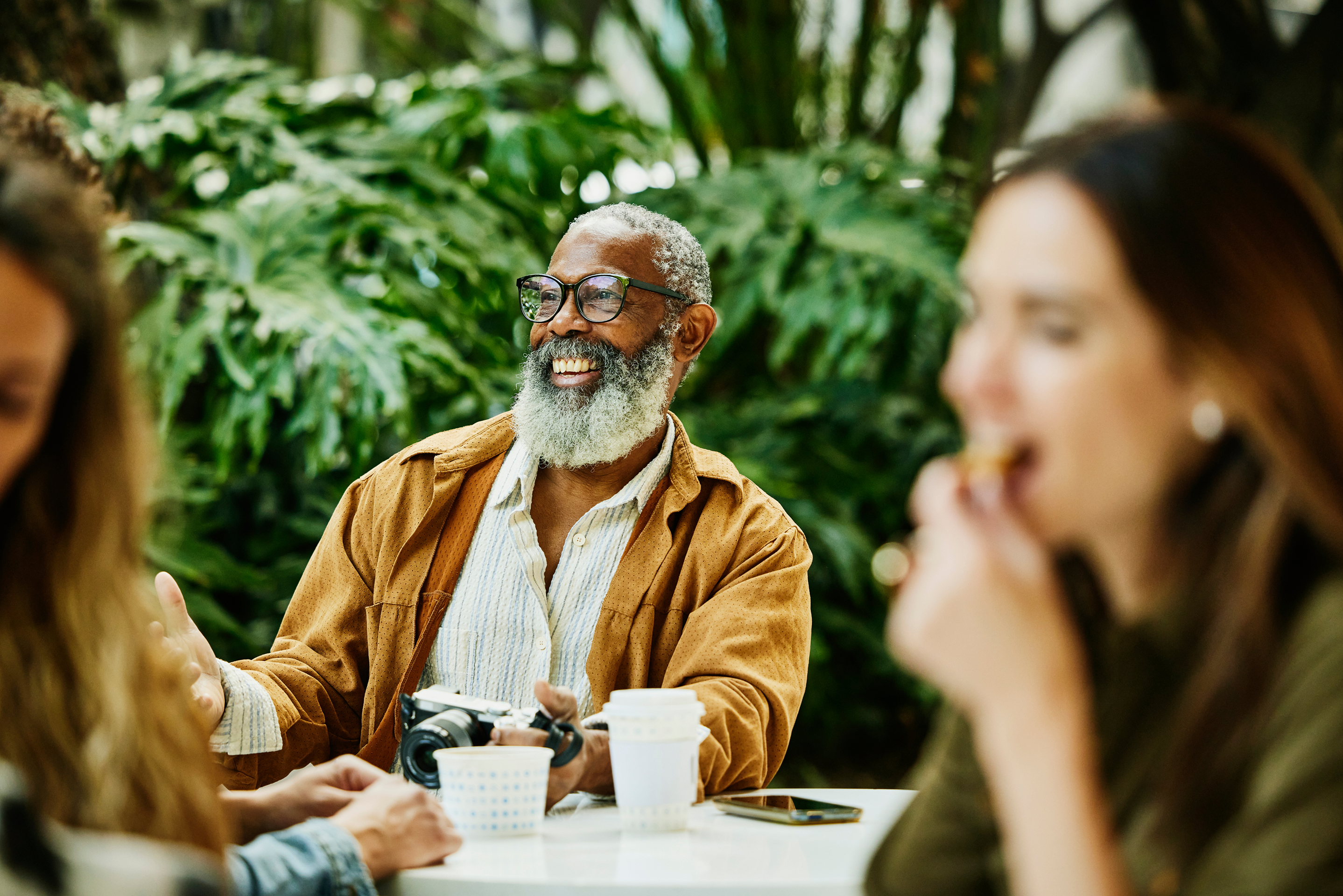 Man sits on a patio smiling.