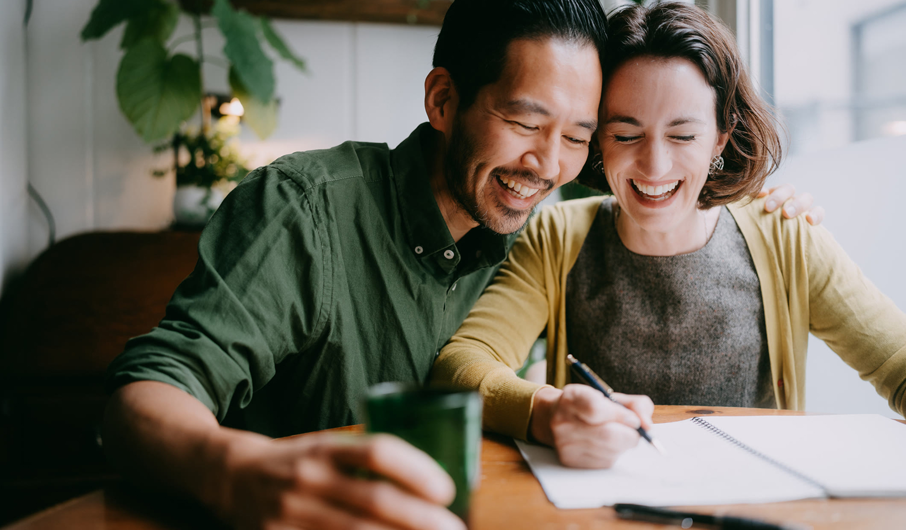 Couple reviewing financial documents, planning 529 college savings.
