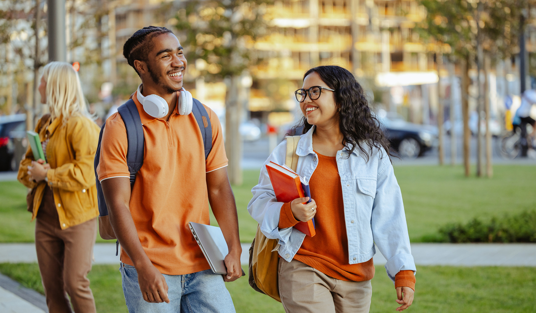 Two college students talking on campus, reflecting education planning.