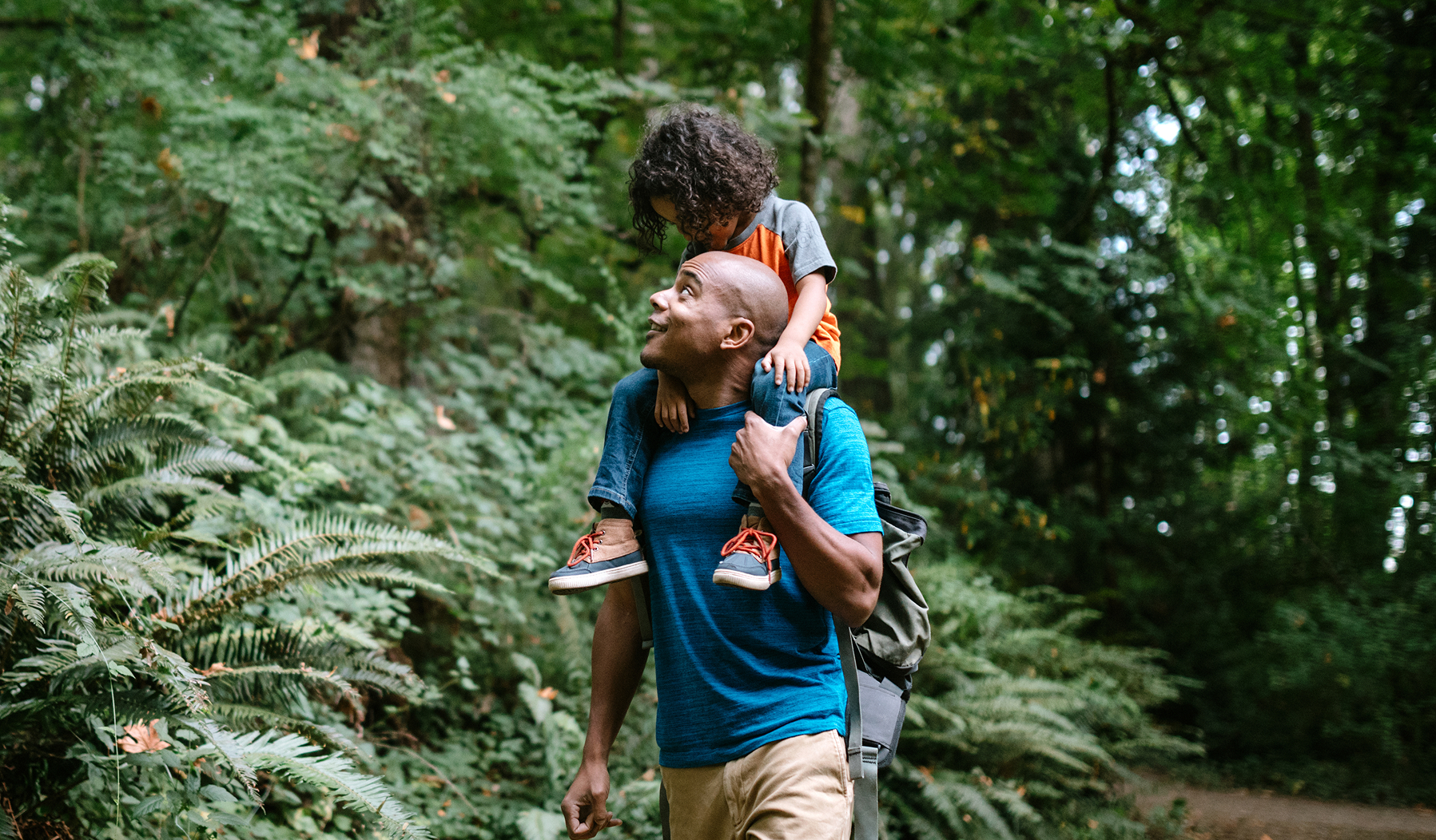 Two women with a toddler on their home steps, representing family education savings.