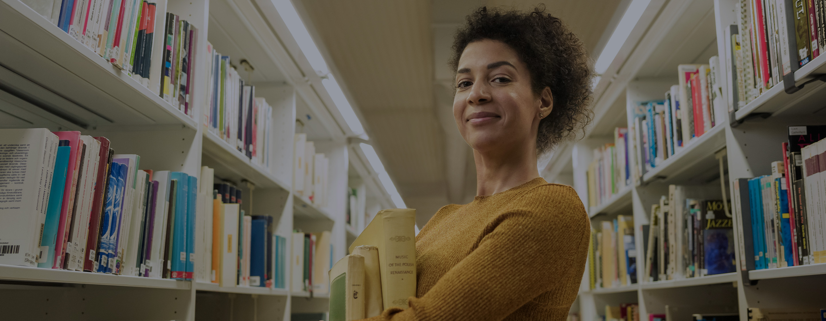 Woman in a library holding books