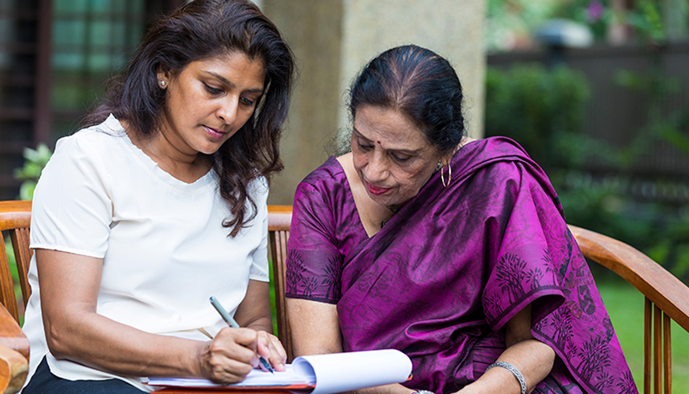 writing-a-will_8.jpg Two women work on writing a will