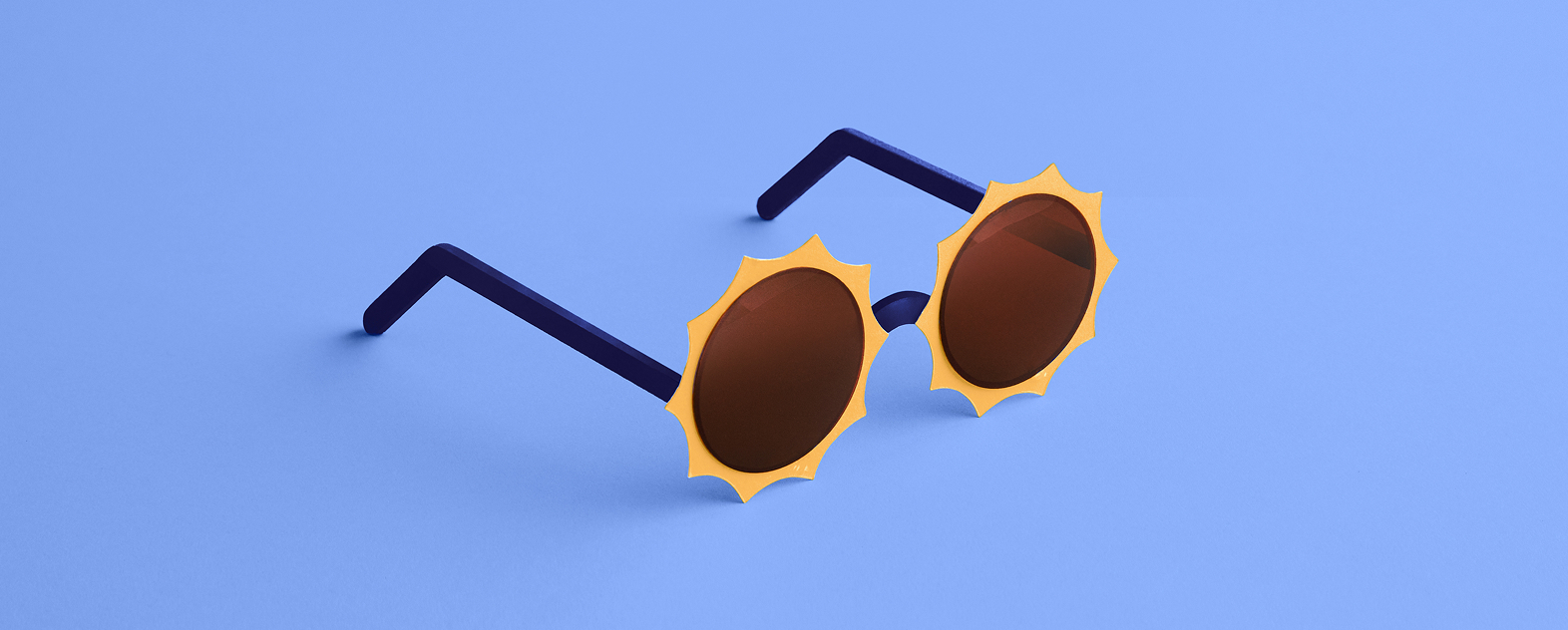 A pair of sunglasses with yellow rims