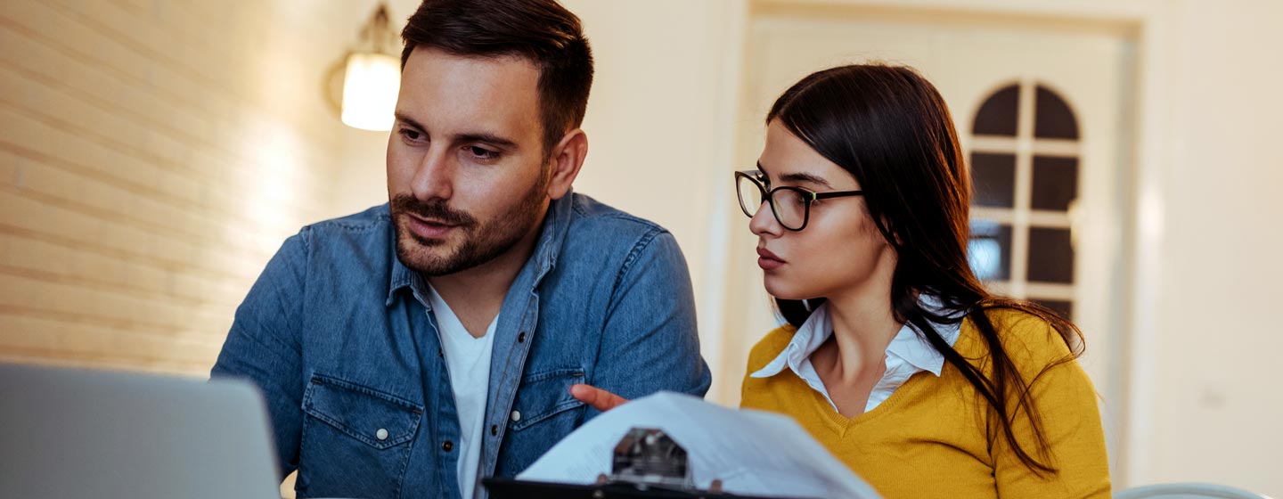 Man and woman looking at a laptop
