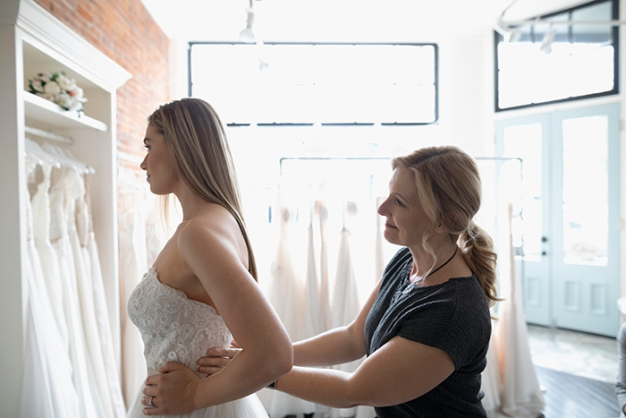 A bride tries on a wedding dress
